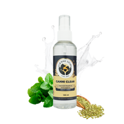 Isolated Canni Clean pet mouth spray bottle with mint leaves, fennel seeds, and a water splash on a checkered background.