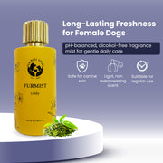 A lifestyle product visual featuring the Furmist Lady bottle resting on a white podium with a pile of fresh green tea leaves at its base. The text describes it as a "Long-Lasting Freshness" mist designed specifically for the gentle care of female dogs.