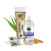 A product display of Eczo Pet cream and Shampooch Dermaprove shampoo, surrounded by raw natural ingredients like aloe vera, turmeric, and neem leaves in a mortar and pestle.