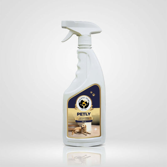 Front view of a white spray bottle of Petly Antibacterial Surface Cleaner featuring a dog on the label.