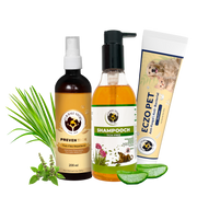 A complete pet care bundle featuring Preven Tick spray, Shampooch shampoo, and Eczo Pet cream arranged with fresh lemongrass, tulsi, and aloe vera slices on a transparent grid background.
