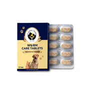 A front view of "Fur Ball Story" Worm Care Tablets alongside a silver blister pack of 10 speckled, tan herbal caplets. The navy and cream packaging features a friendly golden retriever and a ginger cat, highlighting its use for multi-pet households.