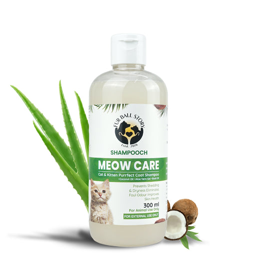A 300ml bottle of Fur Ball Story Meow Care cat shampoo, flanked by green aloe vera stalks and a cracked open coconut.